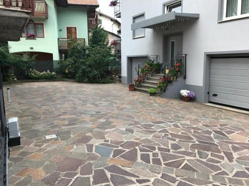 a stone patio in front of a house at Nenez B&B in Giovo