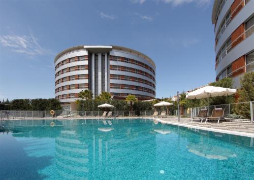 a large swimming pool in front of a building at Hotel Abades Nevada Palace in Granada