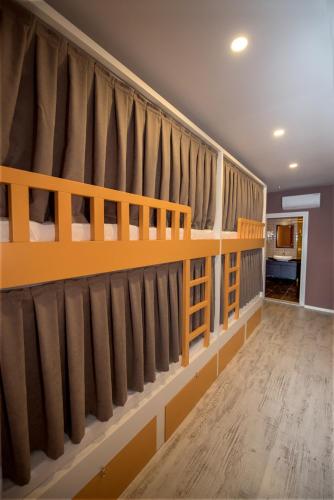 two bunk beds in a room with curtains at Sakura Hostel Fethiye in Fethiye
