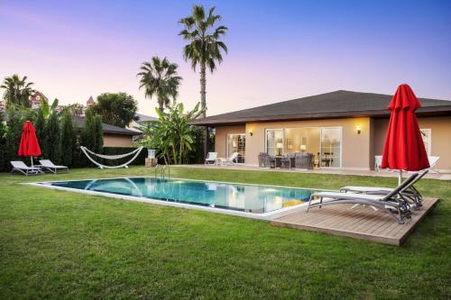 a backyard with a hammock and a house at IC Hotels Santai Family Resort - Kids Concept in Belek