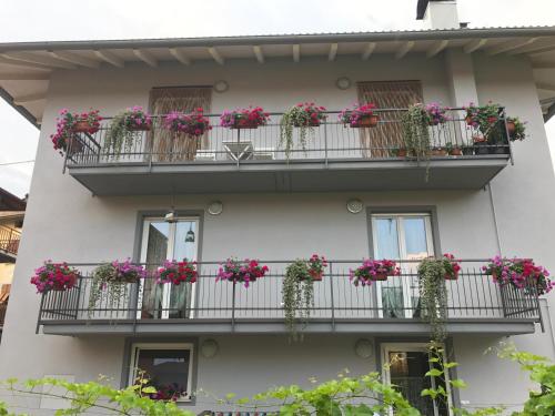 a building with flowers on its balconies at Nenez B&B in Giovo