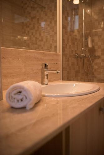 a bathroom sink with a towel on a counter at Apartamente Felix in Baile Felix
