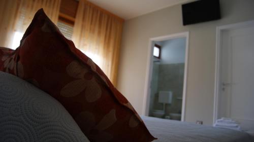 a bedroom with a bed with a pillow and a window at Le Stanze di Lucia vicino Ospedale Cardinale Panico a Tricase in Tricase