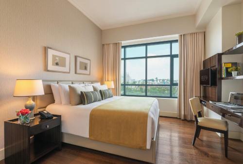 a hotel room with a large bed and a large window at Aruga Apartments by Rockwell Makati -Staycation Approved in Manila