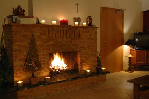 a fireplace with candles and a christmas tree in it at Villa Irene in Rienne