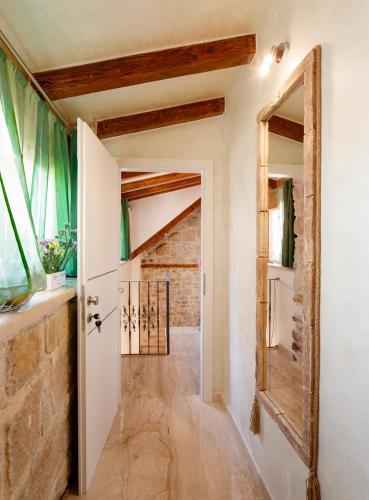 a hallway with a door and a brick wall at Stone house luxury rooms in Split