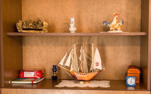 a shelf with a model of a sail boat on it at Apartments The heart of Croatia in Pirovac