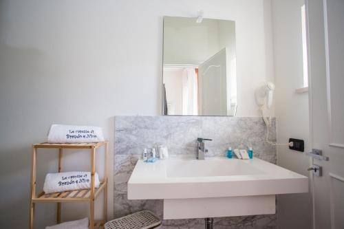 a bathroom with a white sink and a mirror at Le Stanze Di Brando E Nico in Tricase
