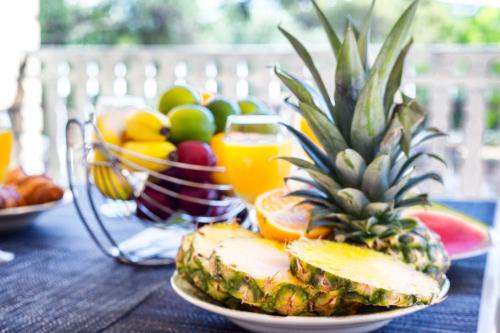 a plate of fruit on a table with a bowl of fruit at Apartments The heart of Croatia in Pirovac