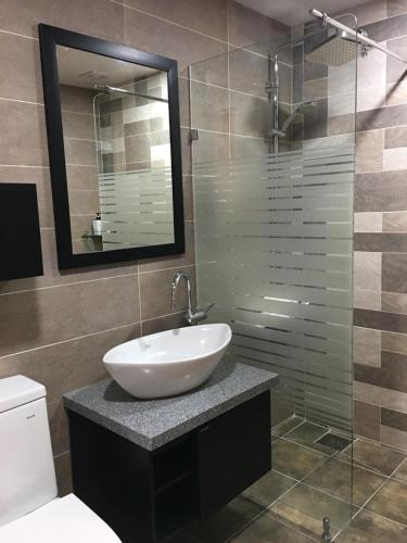 a bathroom with a sink and a glass shower at The Beauty Hotel in Gangneung