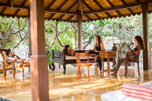a group of women sitting at a table on a patio at Amritara Aura Resort & Spa in Mandrem