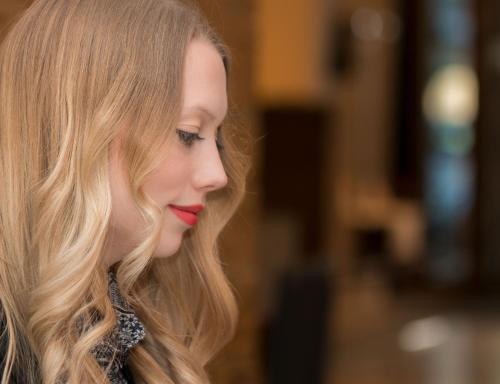 a woman with long blonde hair and red lipstick at Downtown Vi Vadi Hotel in Munich