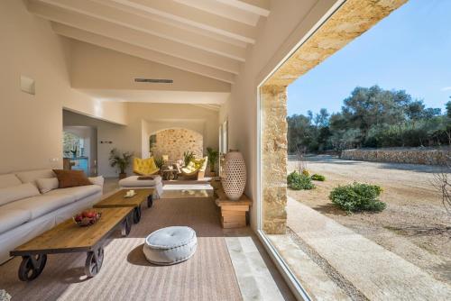 a living room with a couch and a table at Es Lligats Agroturismo - Adults Only in Sant Llorenç des Cardassar