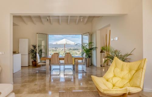 a dining room with a table and chairs and an umbrella at Es Lligats Agroturismo - Adults Only in Sant Llorenç des Cardassar