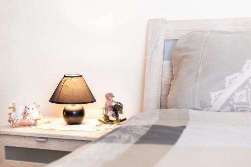 a lamp on a table next to a bed at Apartments The heart of Croatia in Pirovac