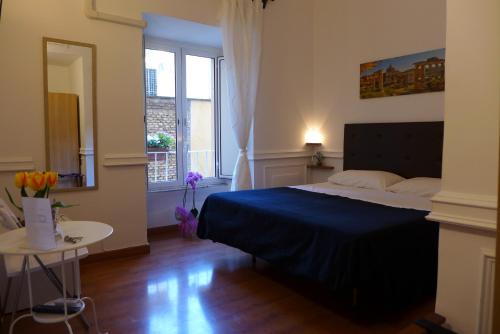 מיטה או מיטות בחדר ב-Residenza Vespasiano