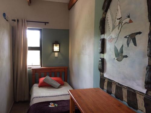 En eller flere senge i et værelse på Guinea Feather Country Lodge & Spa