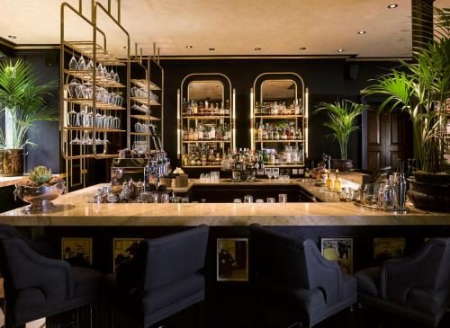a bar in a restaurant with a large counter at Blakes Hotel in London