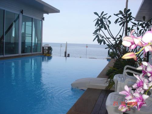 a swimming pool with a view of the ocean at Baancivilize Resort in Khanom