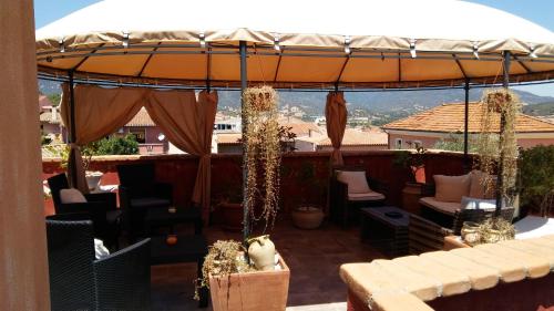 an umbrella on top of a patio with a view at Hotel Sa Cralla Villasimius in Villasimius