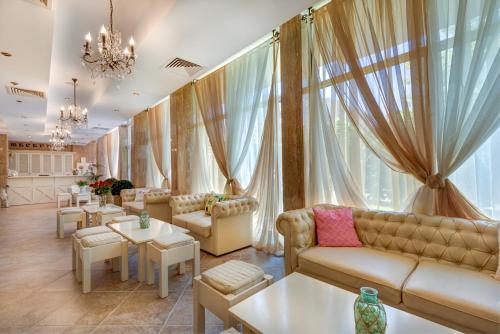 a living room filled with furniture and a large window at Aparthotel Dawn Park in Sunny Beach