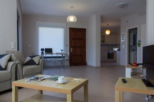 a living room with a couch and a table at Perivoli House A in Skala Eresou