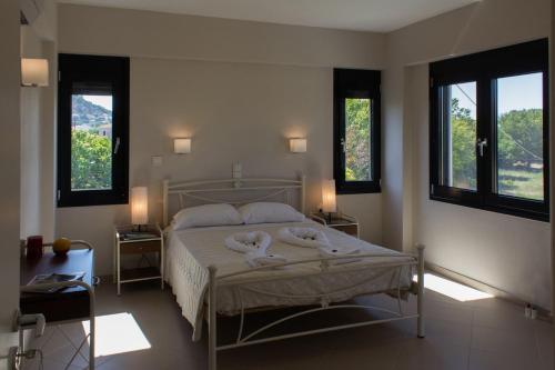 a bedroom with a bed with two towels on it at Perivoli House A in Skala Eresou