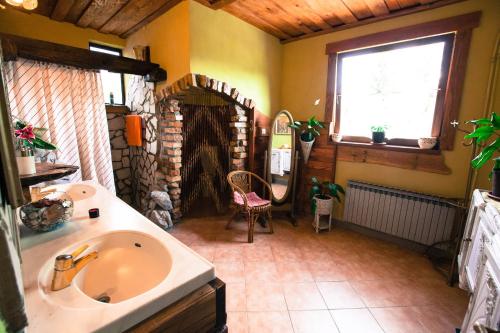 a bathroom with a sink and a large window at Šumski Dvori Apartment in Ogulin