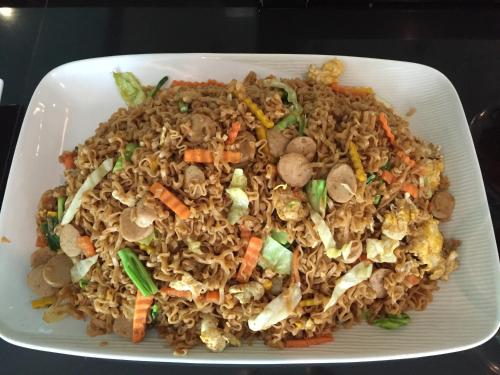 a plate of food with rice and vegetables at Baancivilize Resort in Khanom