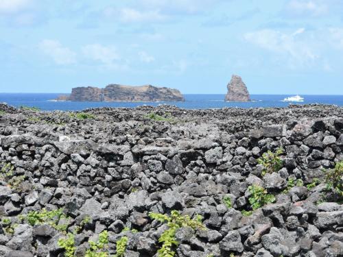 a large rock field with two islands in the ocean at Vila Barca in Madalena