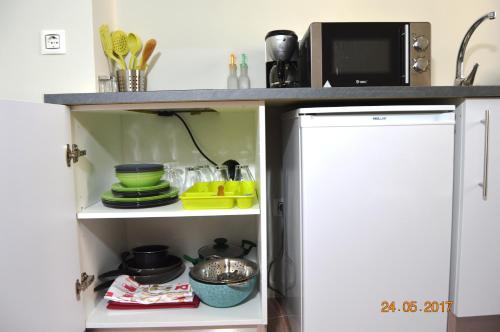 a kitchen pantry with a microwave and a refrigerator at Center Plaza Figueres in Figueres