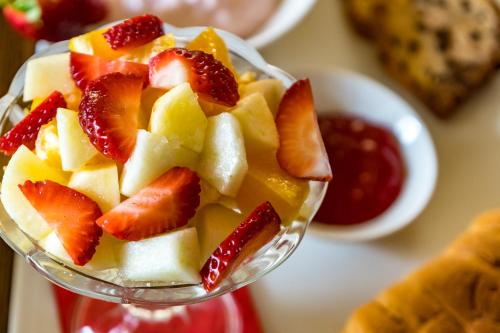 a glass dish filled with fruit on a table at Il-Logga Boutique Hotel in Xagħra