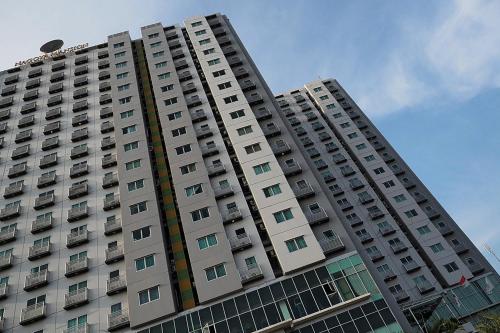 a tall apartment building with balconies on it at Nagoya Mansion Hotel and Residence in Nagoya