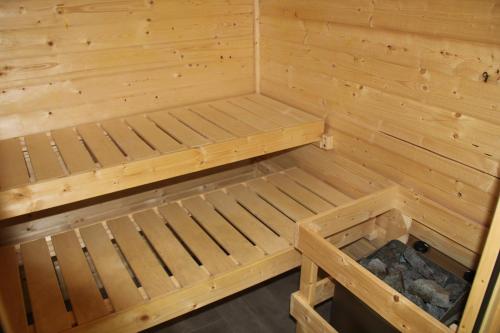 a small wooden sauna with a bed in it at Bergblick-Planai - 5 Schlafzimmer plus eigene Sauna in Schladming