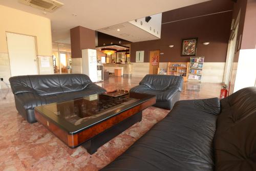 a living room with two couches and a coffee table at APA Hotel Suzuka-Chuou in Suzuka
