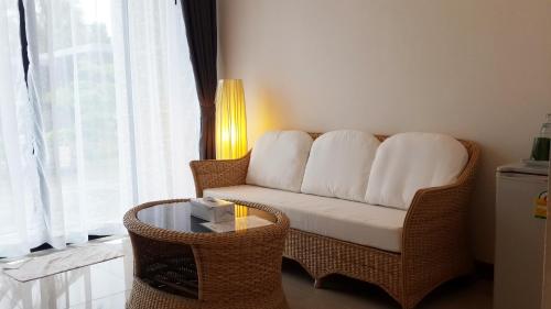 a living room with a couch and a table at Baancivilize Resort in Khanom