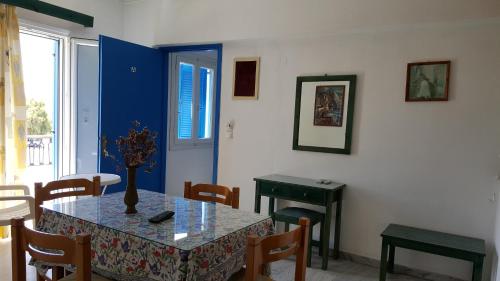 a dining room with a table with a vase on it at Hotel Rea in Naxos Chora