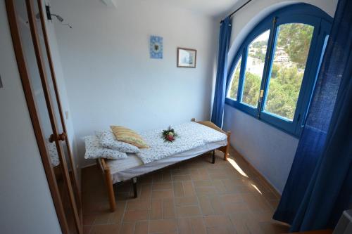 a room with a bench with a window at Lloret Apartments in Lloret de Mar