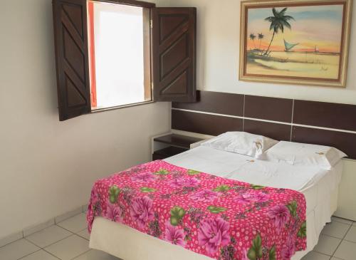 En eller flere senge i et værelse på Pousada Tambaú