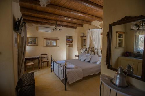 a bedroom with a bed and a table in a room at Kritikies in Pitsidia