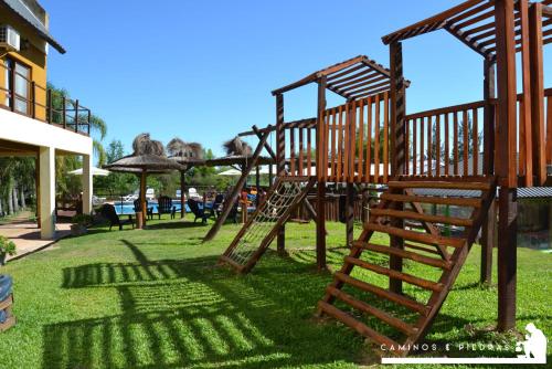 a wooden playground with a slide in the grass at Terrazas de Colón in Colón