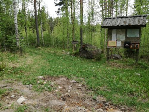 a sign in the middle of a forest at Mieps Huset Dalarna Holiday in Kullen