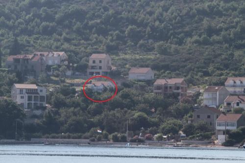 a red object in the air in front of houses at Guest House Pavkovic in Slano