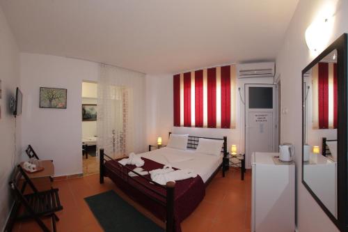 a bedroom with a bed and a room with a desk at Casa Panos in 2 Mai