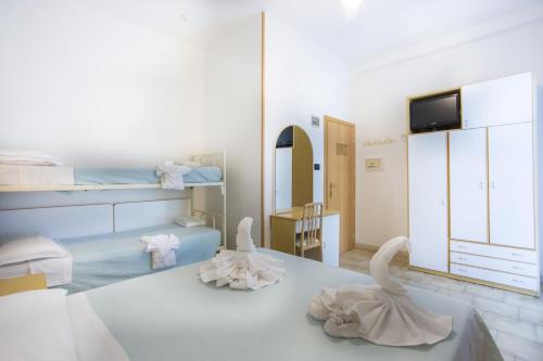 Albergo Villa Denny tesisinde bir odada yatak veya yataklar