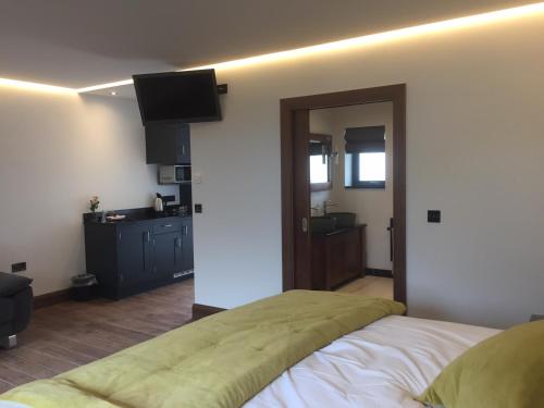 a bedroom with a bed and a television on the wall at Antrim House Guest Rooms & Suites in Portrush