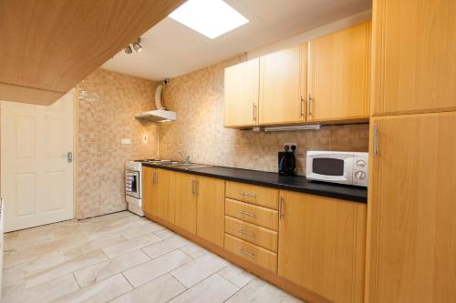 a kitchen with wooden cabinets and a microwave at Dublin Vacation Rentals in Dublin