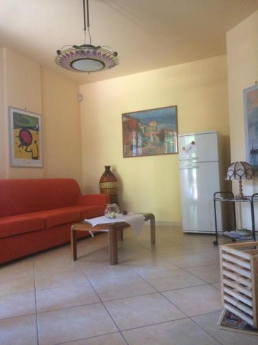 a living room with a couch and a table and a refrigerator at Villa Margherita in Montaquila