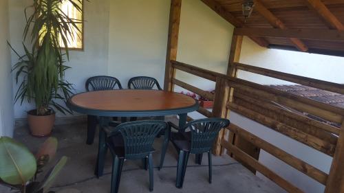 a table and chairs on the balcony of a house at Apartment Sajra in Kulen Vakuf