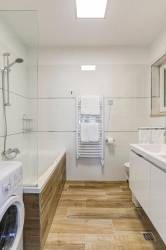 a bathroom with a washing machine and a sink at Viras Luxury Holiday in Premantura
